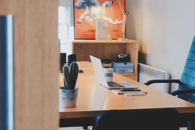 Modern office workspace with laptop on conference table
