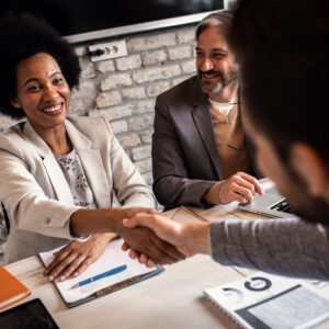 Businessrecruitersshakeshandswithcandidateduringjobinterview
